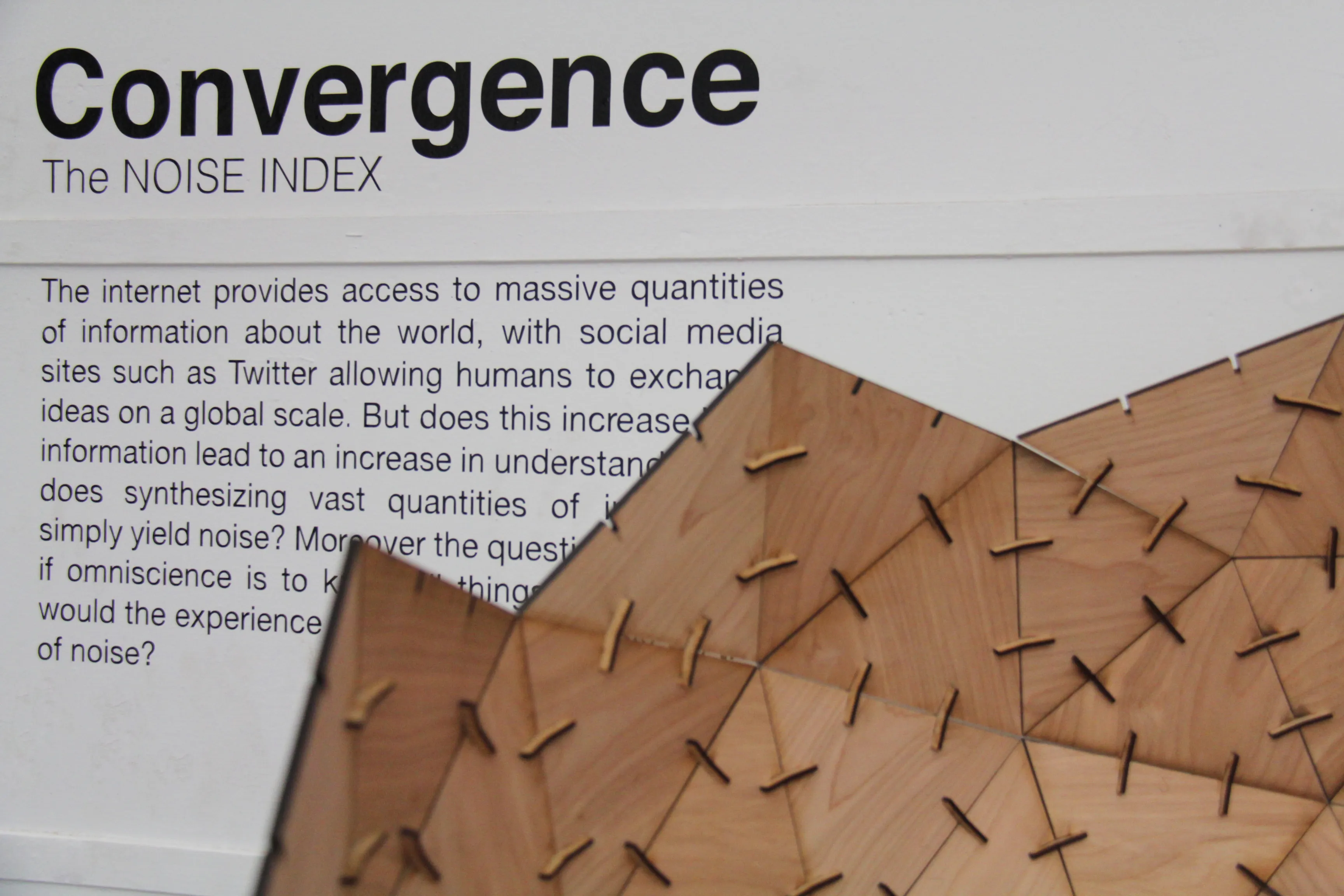 The sphere's upper edge cutting diagonally across the wall text, grain and angled tabs in sharp focus.